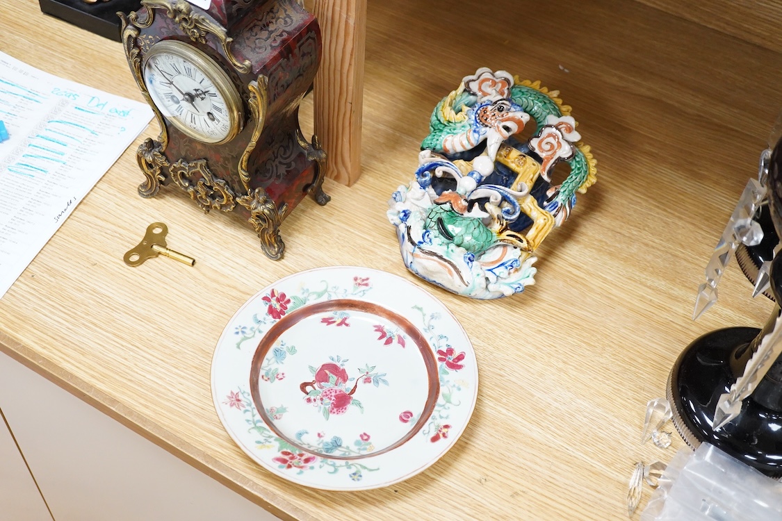 An 18th century Chinese porcelain plate enamelled with flowers and a Chinese Sancai type wall pocket, largest 25cm high